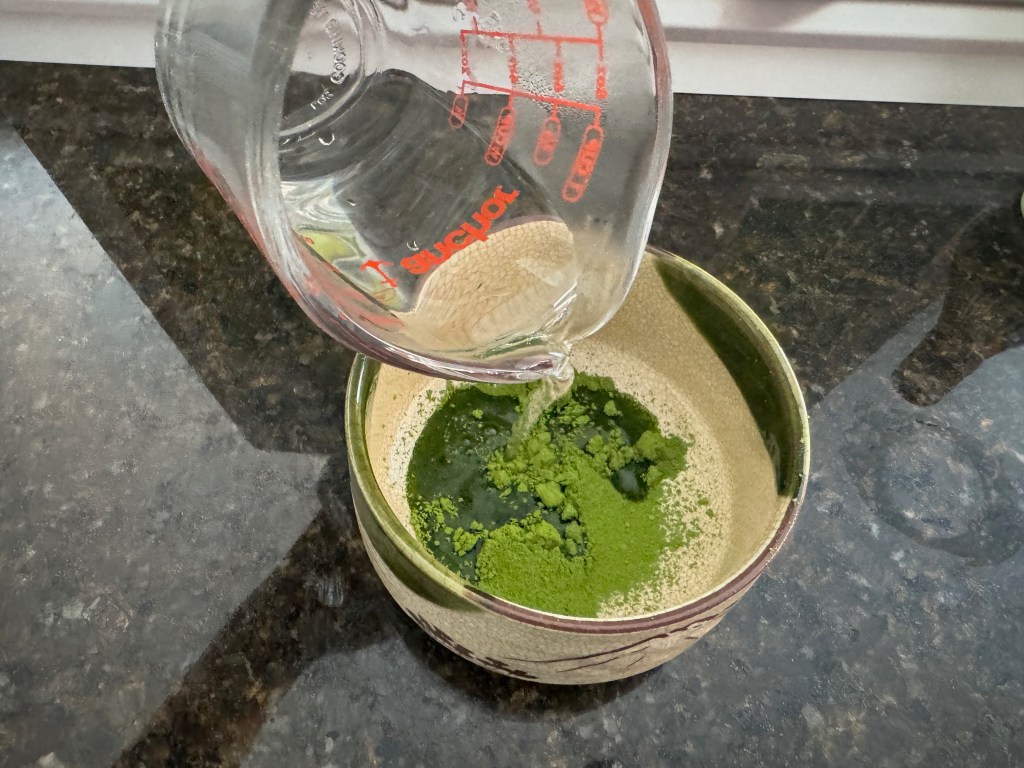 Pour water into matcha powder
