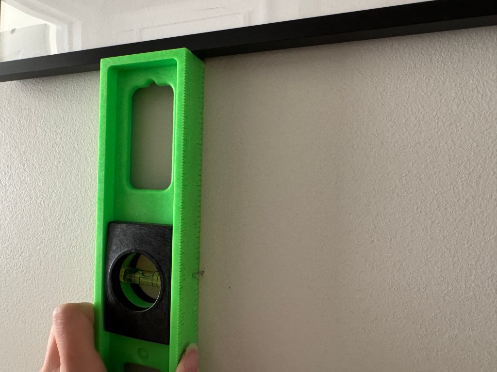 Measuring where the first nail in the second row goes.